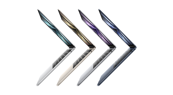 Angled row of MacBook laptops in different colors arranged in a zigzag pattern.