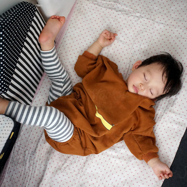 boy sleeping in restless position