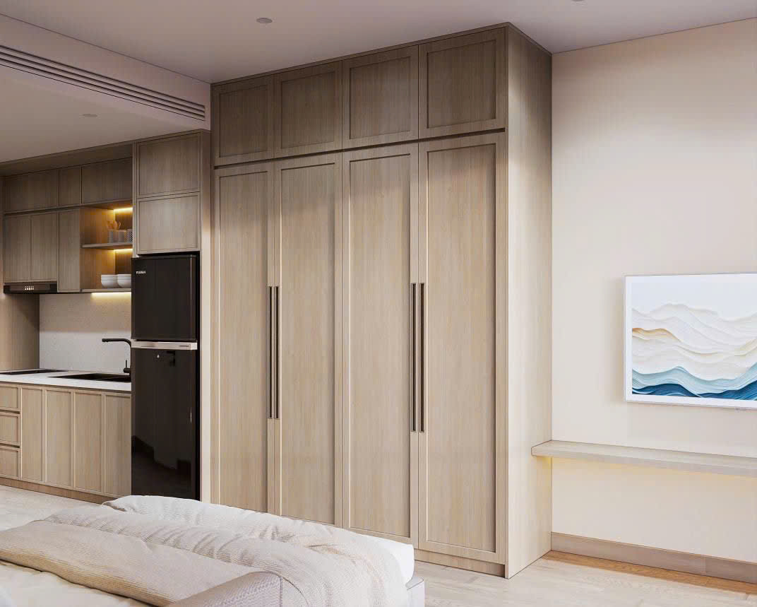 Không gian phòng khách liền bếp hiện đại trong căn hộ Studio The Onsen với gam màu trung tính.