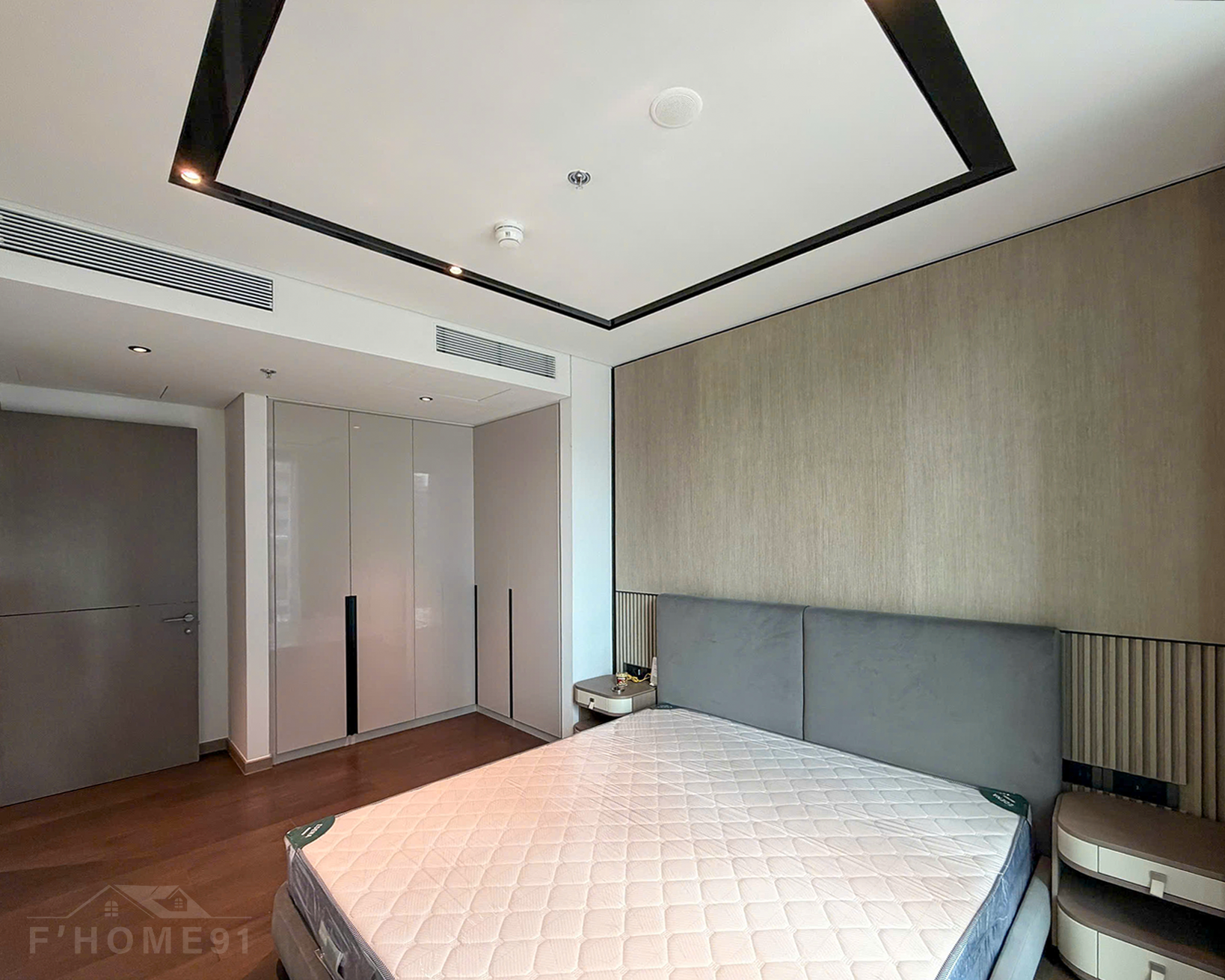 Cozy wooden floor bedroom inside a Grand Marina Saigon 1 bedroom apartment for lease.