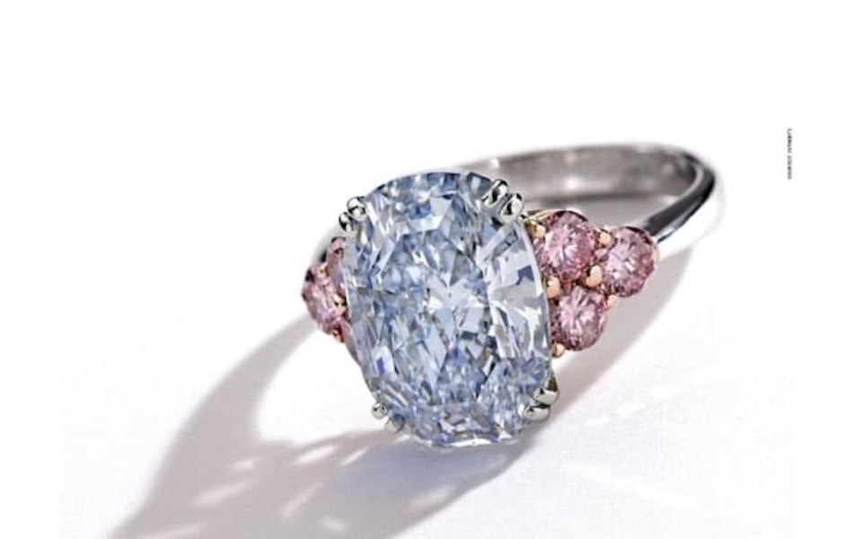 Blue diamond ring with surrounding pink diamonds