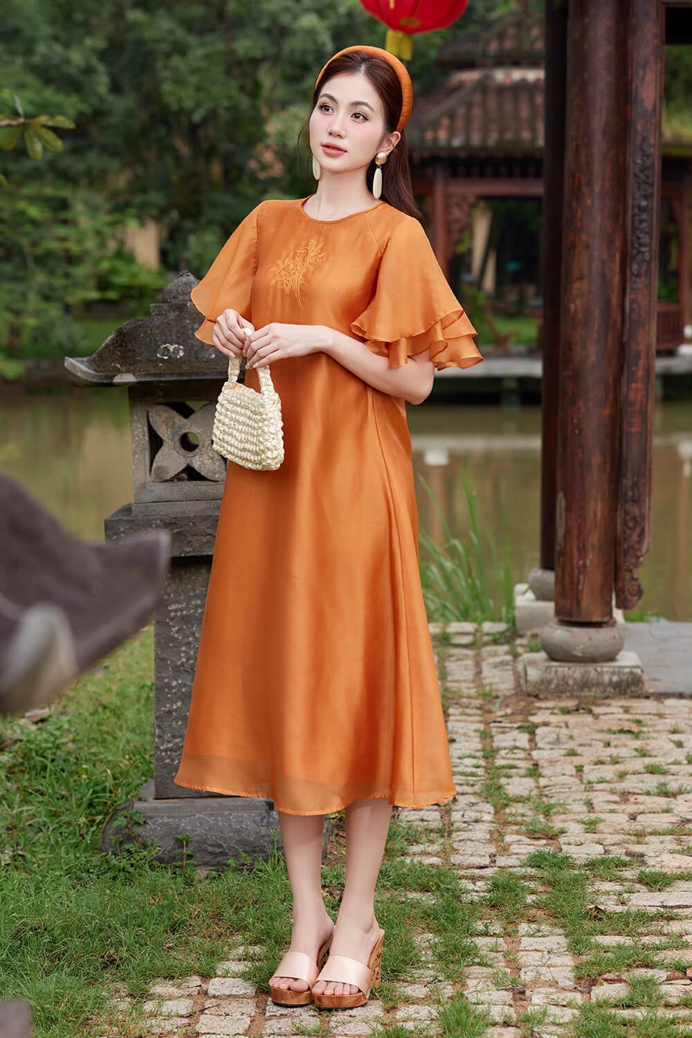 20. Áo dài lụa cam tay bèo tầng thêu hoa ngực