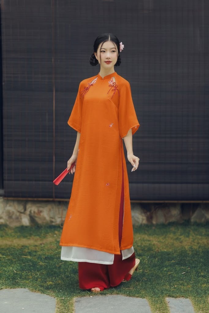 3. Áo dài cách tân màu cam tay loe cut-out vai