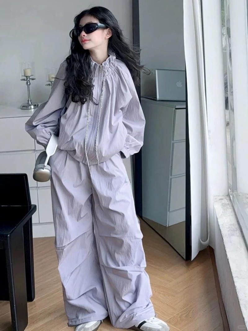 20. Set áo khoác gió + Quần dù ống rộng màu tím pastel + Kính râm