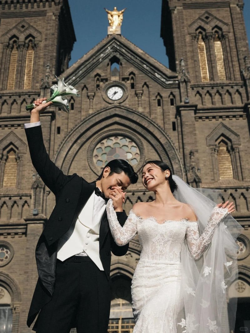 Chú rể hôn tay cô dâu, nâng cao bó hoa hạnh phúc