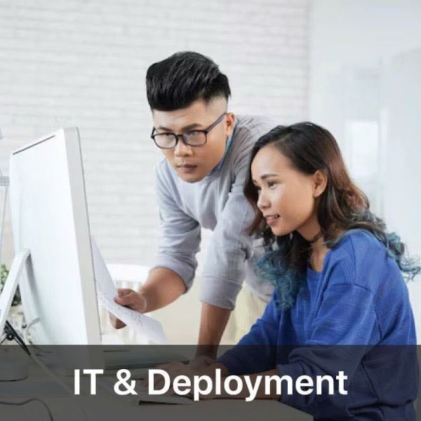 Two people working together on a computer with “IT & Deployment” text overlay.