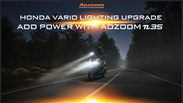 A Honda Vario scooter at night with its visibility dramatically enhanced by an AOZOOM π35 auxiliary spotlight.