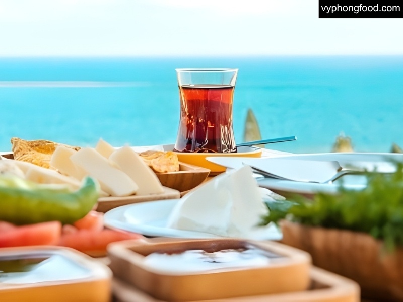 A glass of South African Rooibos tea with ice, lemon and mint on a summer table, showing recipes for iced tea, lemonade, smoothie, latte and kombucha to support better sleep and health.