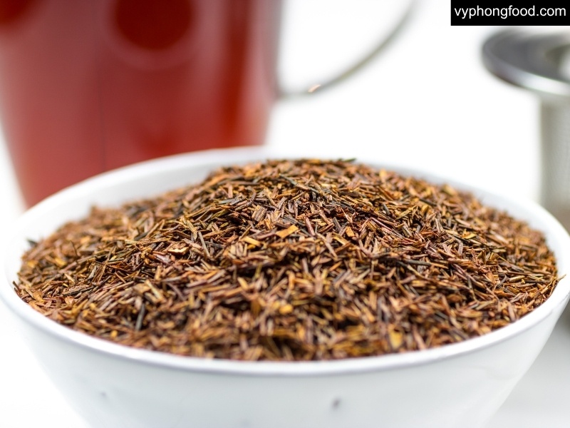 Cup of South African rooibos tea with teabags and a Vietnamese guide overlay, caffeine-free herbal tea, new research highlights, benefits, and easy brewing tips from vyphongfood.com (African Dawn).