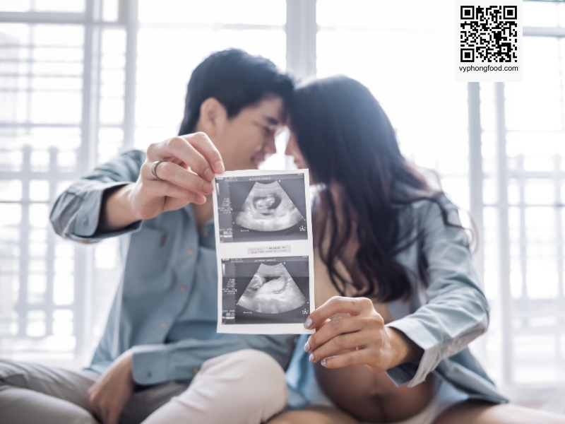 Young pregnant woman reviewing information about Greenmax prenatal nutritional cereal on a screen