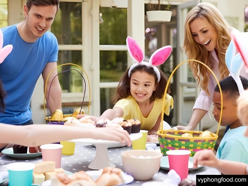 Festive Easter spread featuring South African Rooibos Tea in African Dawn teabags beside carrot cake, hot cross buns, and a chocolate latte—caffeine-free herbal tea, sleep-friendly, family-approved.
