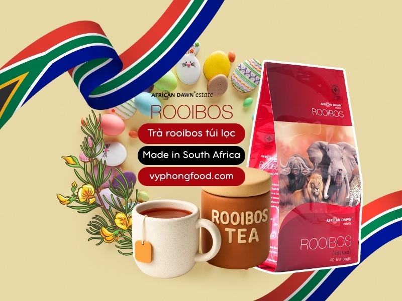 Festive Easter spread featuring South African Rooibos Tea in African Dawn teabags beside carrot cake, hot cross buns, and a chocolate latte—caffeine-free herbal tea, sleep-friendly, family-approved.