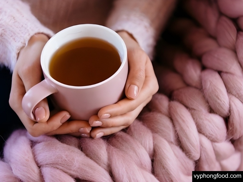 Steaming cup of South African Rooibos tea in teabag form on a winter table—caffeine-free, antioxidant-rich herbal drink for warmth, hydration, and immune support; perfect cozy beverage to keep warm this winter.