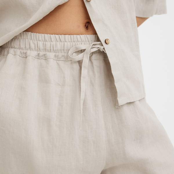 Cận cảnh thân áo và cạp quần dây rút của bộ pyjama lanh