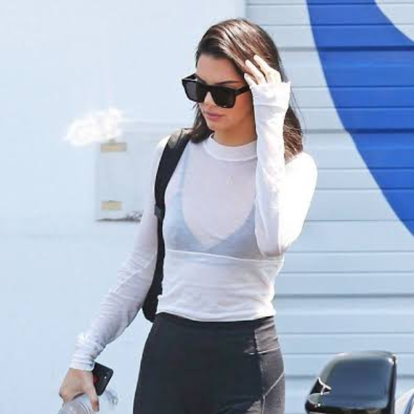woman wearing white T-shirt with black bra visible under