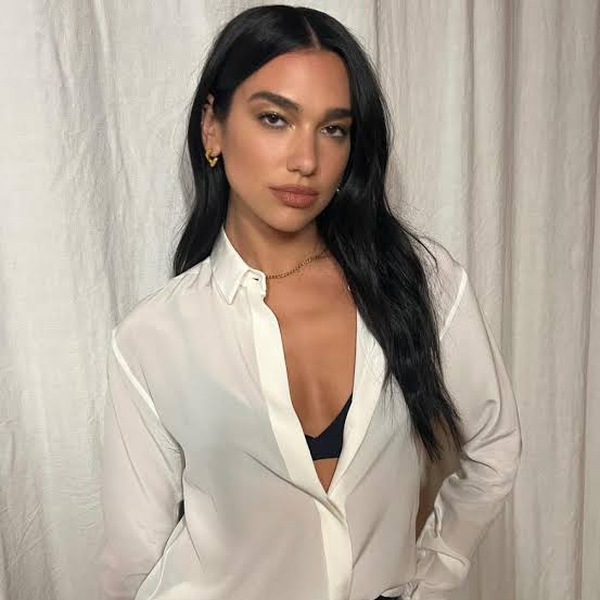 woman being stylish with her black bra half shown under white shirt