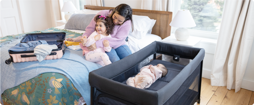 Mum sitting on the floor next to baby in the Joie Serina 2in1 baby swing
