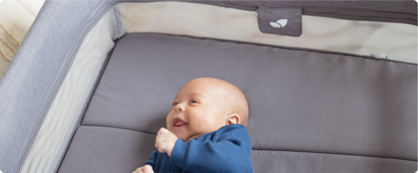 Mum sitting on the floor next to baby in the Joie Serina 2in1 baby swing