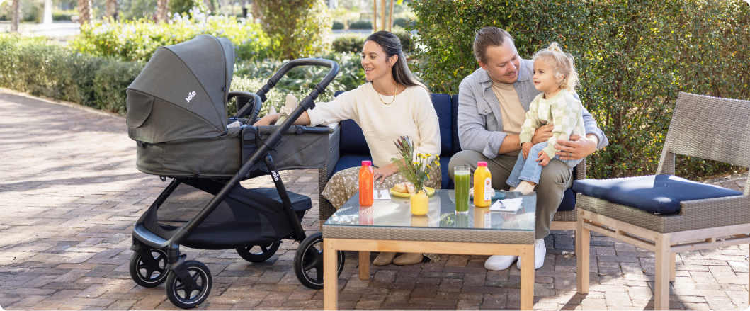 Mum sitting on the floor next to baby in the Joie Serina 2in1 baby swing
