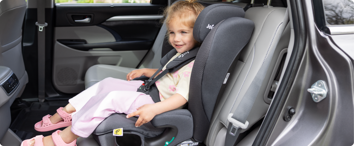Mum sitting on the floor next to baby in the Joie Serina 2in1 baby swing