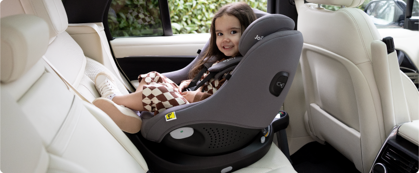 Mum sitting on the floor next to baby in the Joie Serina 2in1 baby swing