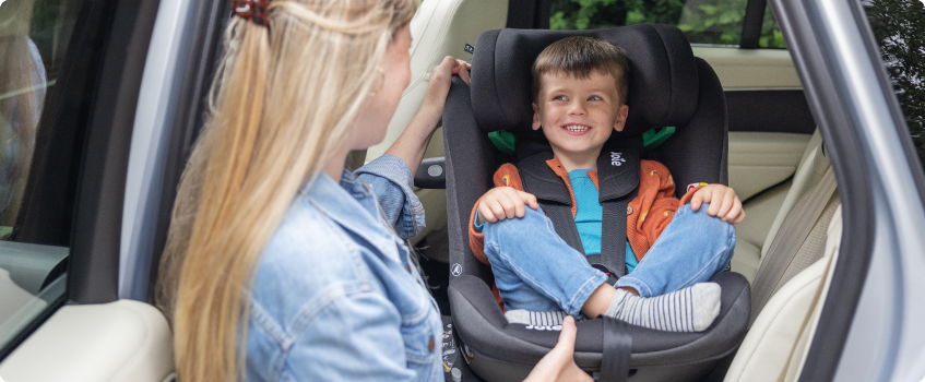 Mum sitting on the floor next to baby in the Joie Serina 2in1 baby swing