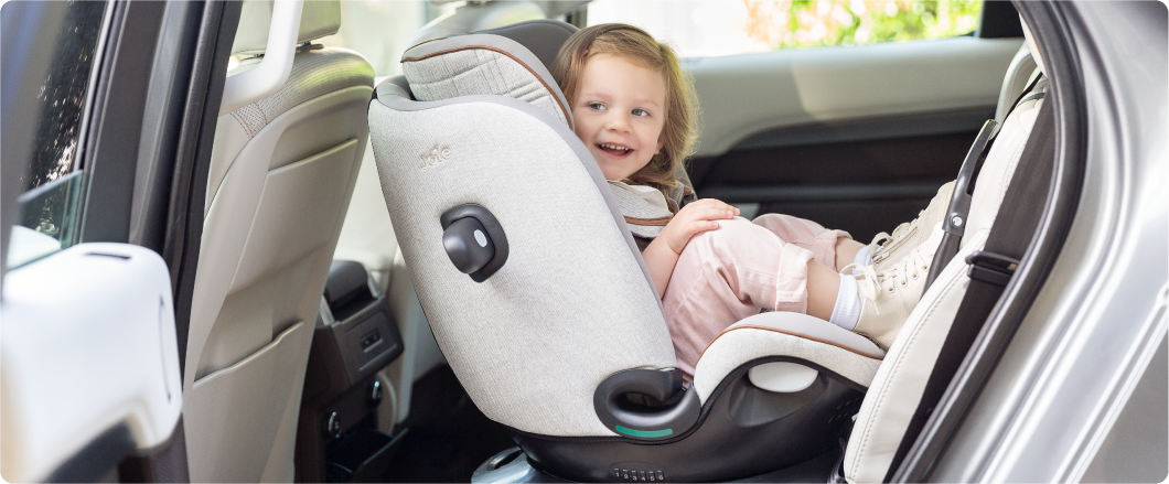 Mum sitting on the floor next to baby in the Joie Serina 2in1 baby swing