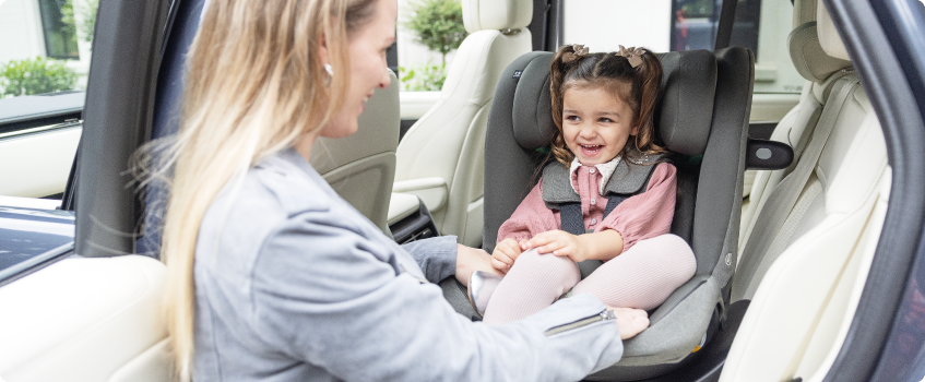 Mum sitting on the floor next to baby in the Joie Serina 2in1 baby swing