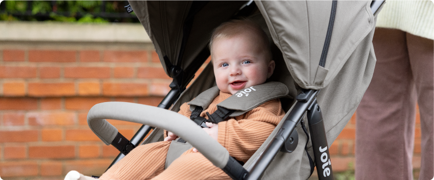 Mum sitting on the floor next to baby in the Joie Serina 2in1 baby swing