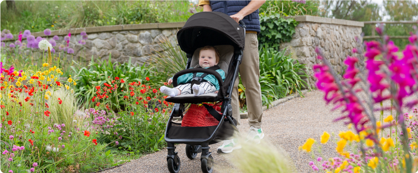Mum sitting on the floor next to baby in the Joie Serina 2in1 baby swing