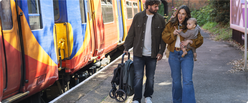 Mum sitting on the floor next to baby in the Joie Serina 2in1 baby swing