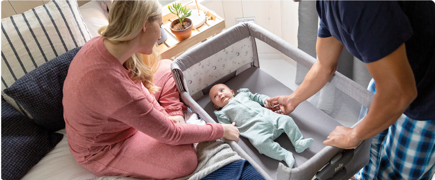 Mum sitting on the floor next to baby in the Joie Serina 2in1 baby swing