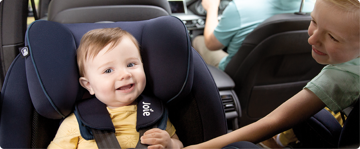 Mum sitting on the floor next to baby in the Joie Serina 2in1 baby swing