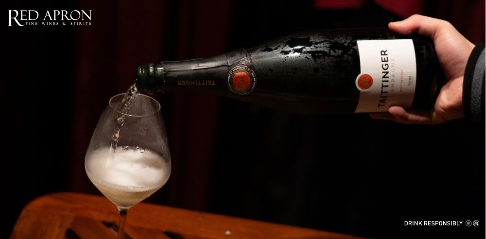 Rượu vang cao cấp làm quà Tết cho người yêu với chai vang và ly vang trong không khí Tết