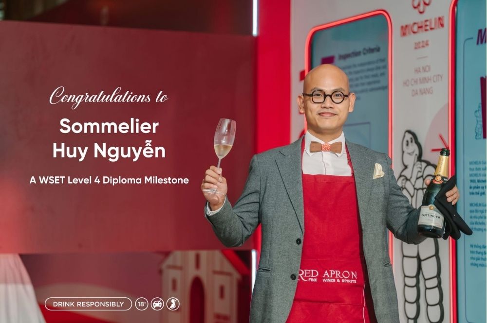 Red Apron sommelier Huy Nguyen holding WSET Level 4 Diploma certificate, representing Vietnamese wine expertise