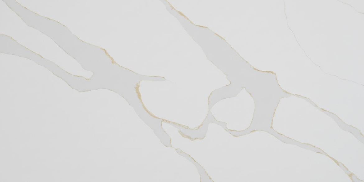 Calacatta Onyx features a crisp white background with broad soft gray veins edged in warm gold, creating a bright luxurious marble look. Its flowing pattern is ideal for countertops, islands, and feature walls.