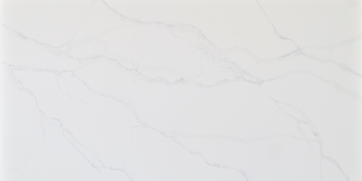 Calacatta Polaris features a bright white background accented by soft, elegant veins available in both cool grey and warm gold tones. Its smooth, flowing movement brings a refined, luxurious look suitable for modern kitchens, islands, and upscale interior designs.