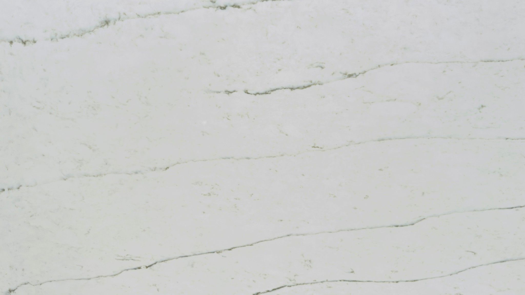 Calacatta Emanto features a soft white background with gentle, linear grey veining that flows subtly across the surface.
