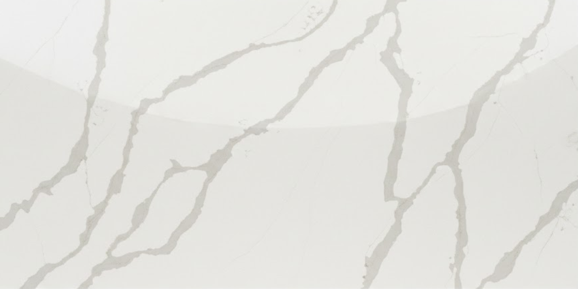 Calacatta Garnet Gold features a crisp white background with soft, flowing grey veins delicately outlined in warm gold.