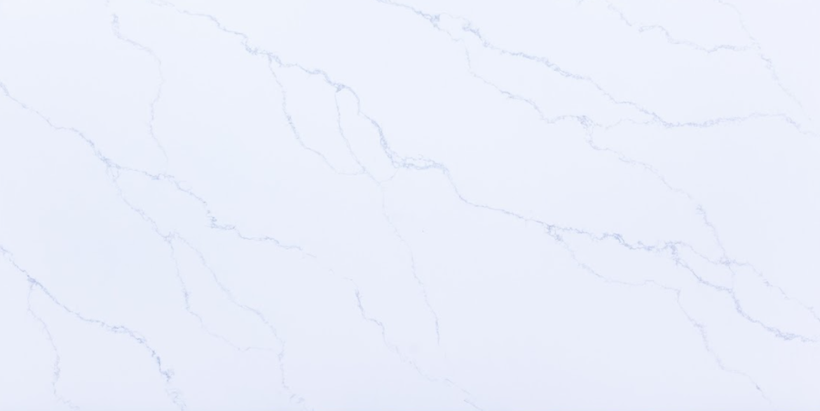 Calacatta River quartz slab with soft flowing grey veining on a bright white background for modern kitchen countertops and interior surfaces