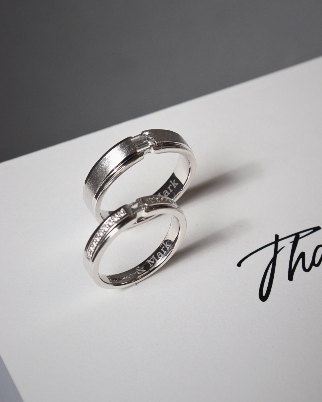 Custom engraved wedding bands designed as a coordinated pair in HCMC