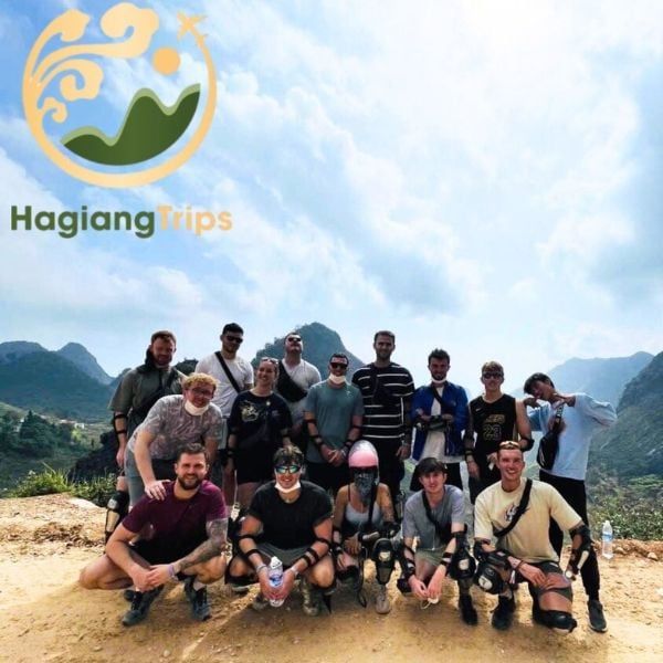 A large group of international travelers posing at a mountain