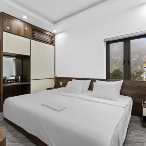 Modern private hotel room with mountain view for luxury Ha Giang Loop tour.
