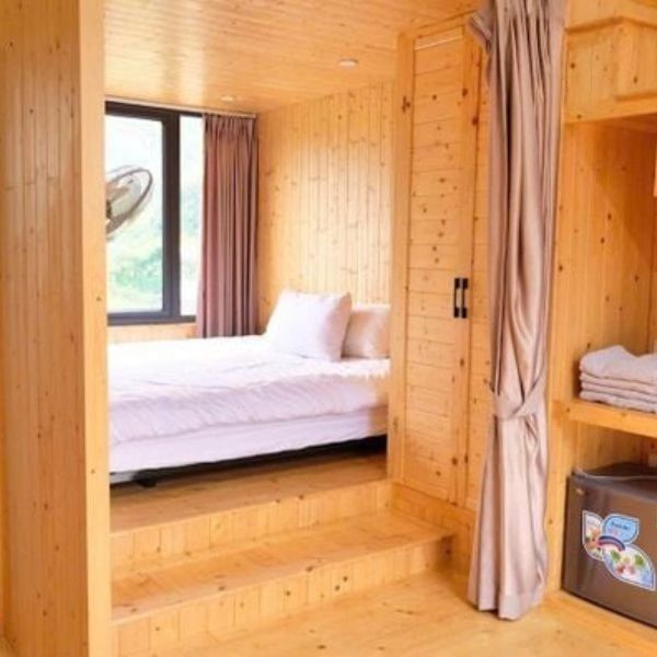 Private wooden bungalow with cozy interior and premium amenities nestled in the serene Du Gia valley.