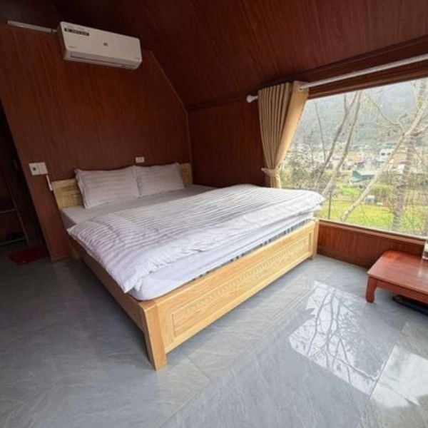 Modern wooden private room at Nungs Homestay in Dong Van with panoramic mountain views.