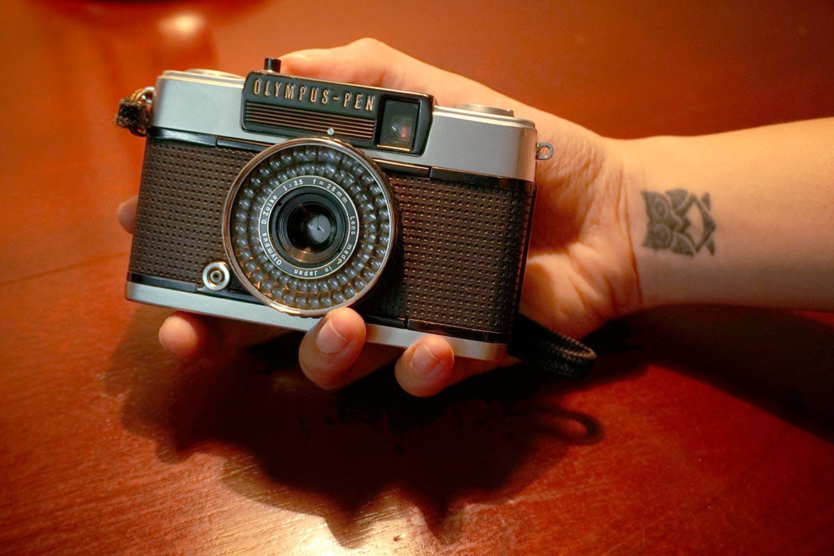 Máy ảnh half-frame là gì? Đây là câu hỏi mà nhiều người yêu thích nhiếp ảnh đặt ra khi tìm hiểu về các loại máy ảnh hiện có trên thị trường. Trong khi máy ảnh full-frame đã trở thành tiêu chuẩn của nhiều nhiếp ảnh gia chuyên nghiệp, máy ảnh half-frame lại mang đến những điều thú vị và độc đáo riêng. Bài viết này sẽ giúp bạn hiểu rõ hơn về máy ảnh half-frame, đặc điểm, chức năng, và điểm khác biệt so với máy full-frame. 1. Máy ảnh half-frame là gì? Để hiểu rõ máy ảnh half-frame là gì, chúng ta cần đi từ khái niệm về kích thước cảm biến và độ phân giải hình ảnh. Máy ảnh half-frame có cảm biến có kích thước gần bằng một nửa so với máy ảnh full-frame. Máy ảnh half-frame thường sử dụng phim 35mm nhưng lại chụp hai bức ảnh trong cùng một khung phim. Điều này có nghĩa là bạn có thể chụp được nhiều bức ảnh hơn trong cùng một thẻ nhớ hoặc một cuộn phim. Vì vậy, nếu máy ảnh full-frame thường cho ra chất lượng hình ảnh cao hơn, máy ảnh half-frame lại tập trung vào việc tối ưu hóa số lượng ảnh.  Máy ảnh half-frame là gì? Lịch sử phát triển của máy ảnh half-frame: Máy ảnh half-frame ra đời vào những năm 1960 và nhanh chóng trở thành một trào lưu mới trong nhiếp ảnh. Ban đầu, nó được thiết kế cho những nhiếp ảnh gia yêu thích việc chụp ảnh đường phố, du lịch. Vì cách chụp ảnh độc đáo, cùng với sự tiện lợi và khả năng chụp nhiều ảnh trong cùng một cuộn phim, máy ảnh half-frame đã thu hút được một số lượng người sử dụng đông đảo. Những thương hiệu như Olympus, Canon và Yashica đã có những sản phẩm đột phá trong lĩnh vực này. 2. Chức năng của máy ảnh half-frame Máy ảnh half-frame không chỉ đơn thuần là một thiết bị chụp ảnh mà còn mang lại rất nhiều chức năng hữu ích cho người dùng. Dưới đây là một số chức năng nổi bật của máy ảnh half-frame. Khả năng chụp liên tiếp: Một trong những đặc điểm nổi bật của máy ảnh half-frame là khả năng chụp liên tiếp. Máy ảnh này cho phép người dùng chụp nhiều bức ảnh trong thời gian ngắn, điều này cực kỳ hữu ích trong việc ghi lại những khoảnh khắc sáng tạo. Kết hợp với các chế độ chụp khác nhau, người dùng có thể tạo nên những bộ ảnh độc đáo mà không cần phải lo lắng về việc tiêu tốn quá nhiều film hoặc thẻ nhớ.  Chức năng của máy ảnh half-frame Chế độ phơi sáng và cấu hình khác nhau: Máy ảnh half-frame thường được trang bị nhiều chế độ phơi sáng tự động và thủ công. Điều này mang lại linh hoạt cho người dùng trong các điều kiện ánh sáng khác nhau. Bạn có thể dễ dàng điều chỉnh độ sáng cho phù hợp với môi trường mà bạn đang chụp. Thiết lập tiêu cự: Không giống như máy ảnh digital hiện đại, máy ảnh half-frame thường có các ống kính được gắn sẵn hoặc có thể thay đổi. Điều này cho phép bạn điều chỉnh tiêu cự để có những bức ảnh từ toàn cảnh đến cận cảnh mà không gặp phải bất cứ trở ngại nào. Kết nối và chia sẻ dễ dàng: Mặc dù máy ảnh half-frame chủ yếu được sử dụng để chụp ảnh film, ngày nay nhiều mẫu máy đã được tích hợp tính năng kết nối với thiết bị di động. Điều này giúp người dùng có thể dễ dàng chia sẻ những hình ảnh đẹp ngay lập tức mà không cần phải chờ đến khi phim được rửa và in. 3. Điểm khác nhau giữa máy ảnh full-frame và máy ảnh half-frame Máy ảnh full-frame và half-frame có nhiều điểm khác nhau, không chỉ về cấu trúc mà còn về khả năng sử dụng. Kích thước cảm biến: Máy ảnh full-frame có cảm biến lớn hơn, tương ứng với kích thước phim 35mm, trong khi đó máy ảnh half-frame có cảm biến nhỏ hơn rất nhiều so với kích thước này.  Điểm khác nhau giữa máy ảnh full-frame và máy ảnh half-frame Kích thước cảm biến lớn hơn giúp máy ảnh full-frame chụp được hình ảnh có độ sâu trường ảnh tốt hơn, khả năng lấy nét cũng tinh tế hơn. Chất lượng hình ảnh: Chất lượng hình ảnh là một trong những yếu tố khác biệt lớn giữa hai loại máy ảnh này. Máy ảnh full-frame thường cho ra hình ảnh sắc nét hơn với độ chi tiết cao, màu sắc chính xác. Điều này có thể thấy rõ khi in ảnh kích thước lớn hoặc khi làm việc với các tệp đồ họa nặng. Máy ảnh half-frame, mặc dù chất lượng hình ảnh không thể so sánh với máy full-frame nhưng lại tạo ra những bức ảnh mang phong cách nghệ thuật độc đáo và đầy sáng tạo. Giá thành và tính năng: Máy ảnh full-frame thường có giá cao hơn so với máy ảnh half-frame, điều này một phần là do trang bị công nghệ tiên tiến hơn. Máy ảnh half-frame phù hợp với những người yêu thích nhiếp ảnh nhưng ngân sách hạn chế, đặc biệt là những người mới bắt đầu. Thêm vào đó, tính đơn giản trong thiết kế máy ảnh half-frame cũng là yếu tố khiến nó ngày càng được ưa chuộng. Đối tượng sử dụng: Hai loại máy ảnh này phục vụ cho những đối tượng khác nhau. Máy ảnh full-frame chủ yếu được sử dụng bởi những nhiếp ảnh gia chuyên nghiệp, trong khi máy ảnh half-frame lại thu hút những người đam mê sáng tạo và nghệ thuật, thích khám phá phong cách chụp ảnh độc đáo. Sau đây là bảng so sánh tóm tắt giữa máy ảnh half-frame và full-frame: Đặc điểm Máy ảnh Full-frame Máy ảnh Half-frame Kích thước cảm biến Lớn Nhỏ Chất lượng hình ảnh Cao Trung bình Giá thành Cao Thấp Tính năng Phức tạp Đơn giản Đối tượng sử dụng Chuyên nghiệp Nhiếp ảnh gia nghiệp dư  4. Các tips sử dụng máy ảnh half-frame hiệu quả nhất Để tận dụng tối đa các chức năng của máy ảnh half-frame, dưới đây là một vài mẹo và hướng dẫn hữu ích dành cho bạn. Thử nghiệm với góc chụp: Một trong những điều tuyệt vời về máy ảnh half-frame chính là sự linh hoạt trong việc thử nghiệm. Bạn có thể thử nghiệm với nhiều góc chụp khác nhau, từ chân dung đến phong cảnh, và từ cận cảnh đến toàn cảnh. Hãy sáng tạo và thử những góc chụp mà bình thường bạn không dám thử. Đôi khi, những bức ảnh đẹp nhất lại đến từ những quyết định không ngờ tới.  Các tips sử dụng máy ảnh half-frame hiệu quả nhất Quản lý ánh sáng tốt: Ánh sáng là một yếu tố quan trọng trong nhiếp ảnh. Để có được bức ảnh chất lượng cao, bạn nên lựa chọn thời điểm chụp thích hợp. Thời gian vàng (golden hour) thường là lúc ánh sáng đẹp nhất. Ngoài ra, bạn cũng có thể tạo ra những hiệu ứng thú vị bằng cách sử dụng ánh sáng để tạo bóng, hoặc thử nghiệm với các nguồn sáng khác nhau như đèn flash hay đèn LED. Khám phá các ống kính khác nhau: Máy ảnh half-frame có thể trang bị nhiều loại ống kính khác nhau. Tìm hiểu về các loại ống kính và cách mà chúng ảnh hưởng đến hình ảnh của bạn là điều vô cùng quan trọng. Hãy thử nghiệm với các ống kính có độ tiêu cự khác nhau để thấy sự khác biệt trong chất lượng hình ảnh mà chúng tạo ra. Chụp nhiều lần: Một ưu điểm nổi bật của máy ảnh half-frame là khả năng chụp nhiều bức ảnh trong cùng một cuộn phim. Hãy tận dụng điều này để ghi lại nhiều khoảnh khắc khác nhau trong cùng một chuyến đi. Đừng ngần ngại đi chụp nhiều lần ở mỗi địa điểm, bạn sẽ bất ngờ với những hình ảnh độc đáo mà mình nhận được. 5. Những câu hỏi thường gặp Mặc dù máy ảnh half-frame đã có mặt trên thị trường một thời gian dài, nhưng vẫn còn nhiều câu hỏi và thắc mắc xung quanh sản phẩm này. Dưới đây là một số câu hỏi thường gặp.  Những câu hỏi thường gặp 5.1 Máy ảnh half-frame có cho chất lượng ảnh thấp hơn máy full-frame không? Có, chất lượng ảnh mà máy ảnh half-frame tạo ra thường không thể so sánh với máy ảnh full-frame. Tuy nhiên, điều đó không có nghĩa là hình ảnh không chất lượng. Máy ảnh half-frame thường hướng đến những bức ảnh mang tính nghệ thuật hơn là kỹ thuật. Điều này làm cho nó trở nên hấp dẫn đối với những người yêu thích sáng tạo. 5.2 Máy ảnh half-frame có dùng được film 35mm thông thường không? Máy ảnh half-frame có thể sử dụng film 35mm thông thường nhưng lưu ý rằng bạn sẽ chỉ chụp được một nửa số bức ảnh mà phim có thể cung cấp. Bạn có thể mua phim chuyên dụng cho máy half-frame để sử dụng một cách hiệu quả nhất. Kết luận Máy ảnh half-frame là một thiết bị nhiếp ảnh thú vị dành cho những ai yêu thích sáng tạo và nghệ thuật. Với kích thước nhỏ gọn, khả năng chụp nhiều bức ảnh và chức năng dễ sử dụng, máy ảnh half-frame mang đến cho người dùng nhiều trải nghiệm độc đáo. Mặc dù chất lượng hình ảnh không thể so với máy full-frame, nhưng máy ảnh half-frame vẫn có chỗ đứng trong lòng những người yêu thích nhiếp ảnh nhờ vào sự sáng tạo và phong cách mà nó mang lại. BH Asia hy vọng bài viết này đã cung cấp cho bạn cái nhìn tổng quan về máy ảnh half-frame, cùng với những mẹo hữu ích để bạn có thể sử dụng hiệu quả.