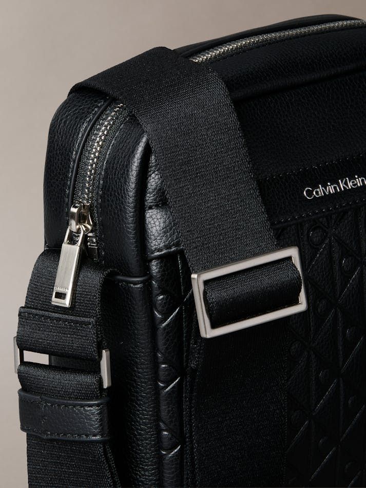 Calvin Klein - Túi đeo chéo nam Embossed Allover Monogram Reporter Bag