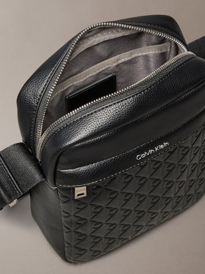 Calvin Klein - Túi đeo chéo nam Embossed Allover Monogram Reporter Bag