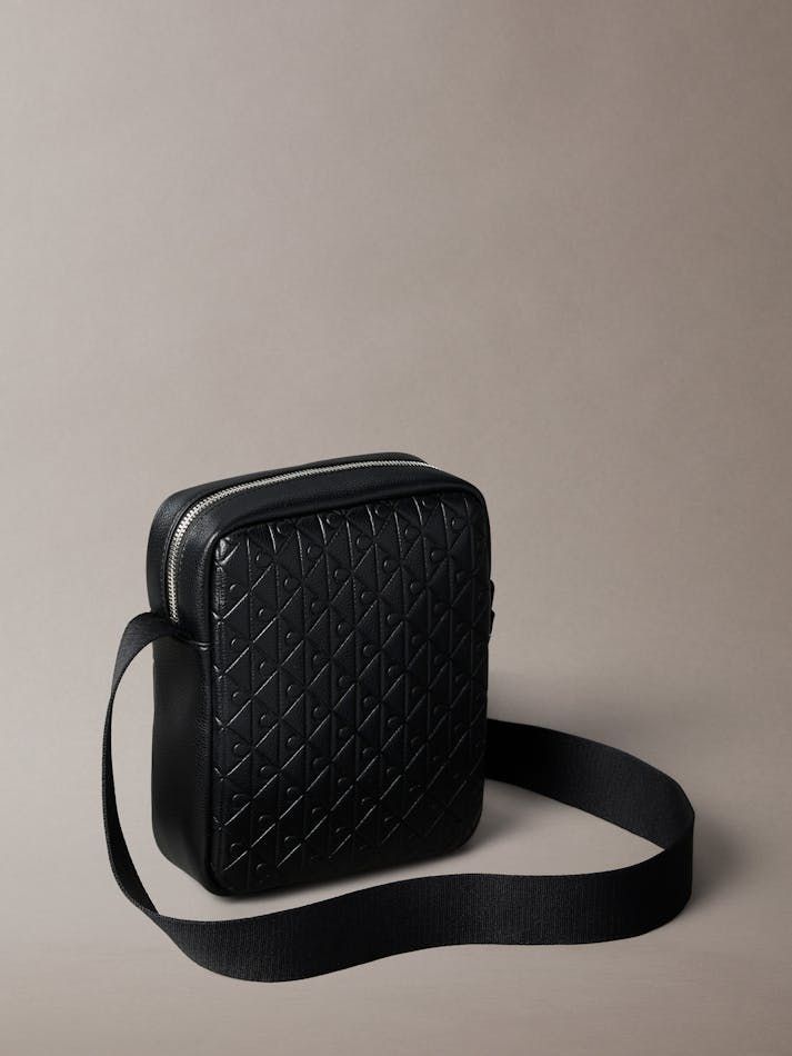 Calvin Klein - Túi đeo chéo nam Embossed Allover Monogram Reporter Bag