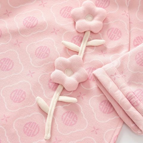 Áo dài hồng nhạt họa tiết Nous đính bông hoa phối quần be